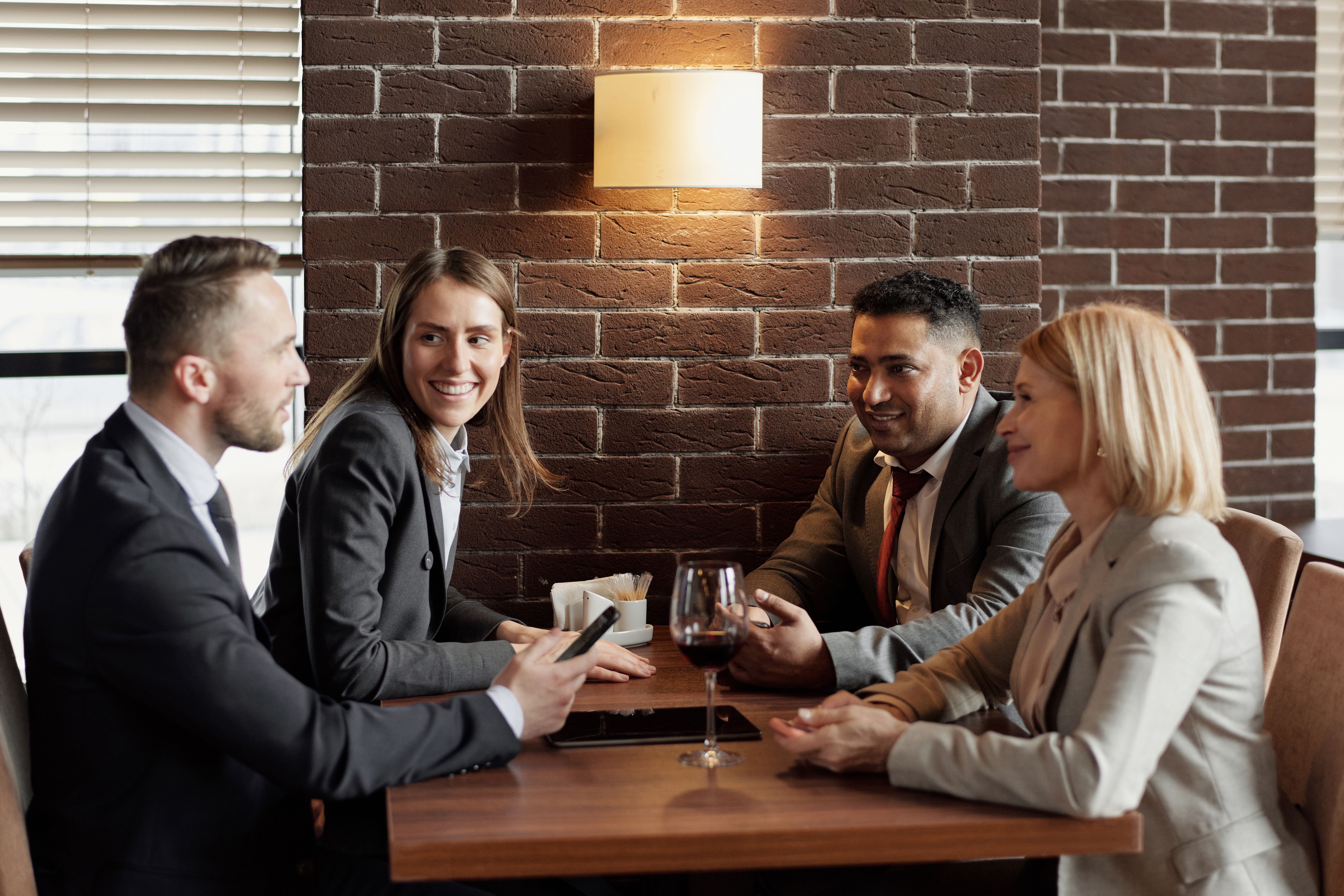 Four local professionals talking around a table