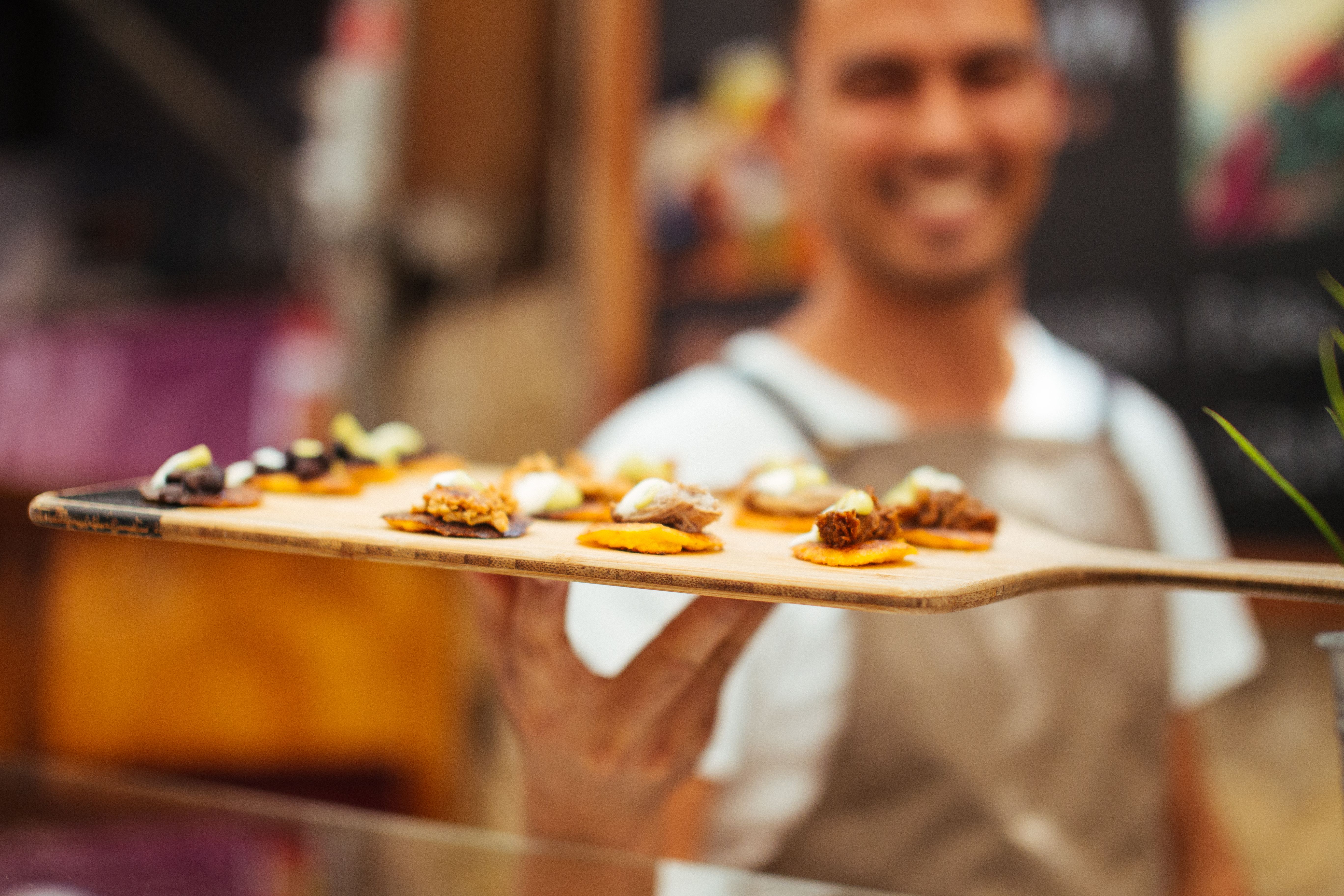 A server carrying small tasting plates